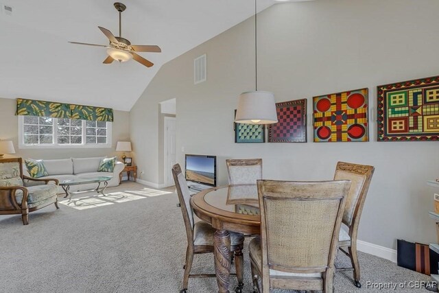 dining space featuring visible vents, a ceiling fan, carpet, and high vaulted ceiling