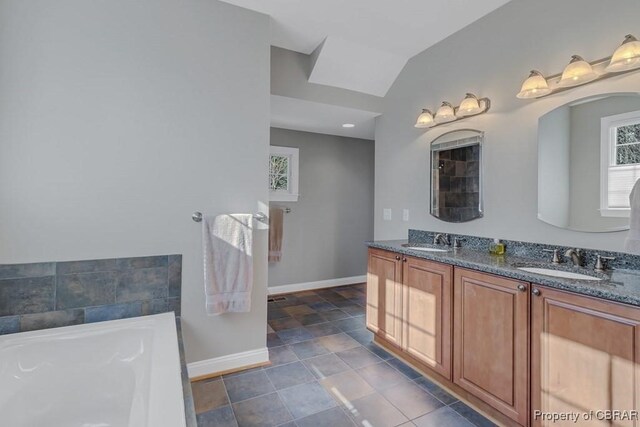 full bathroom with a sink, baseboards, and a healthy amount of sunlight