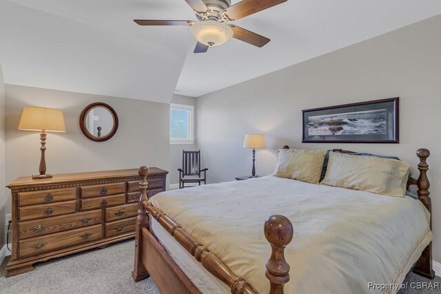 bedroom featuring baseboards, a ceiling fan, lofted ceiling, and light carpet
