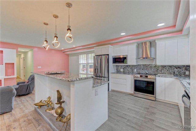 343 Liberty Rd, Buckingham, VA 23123 - kitchen featuring appliances with stainless steel finishes, wall chimney exhaust hood, white cabinets, a center island, and tasteful backsplash
