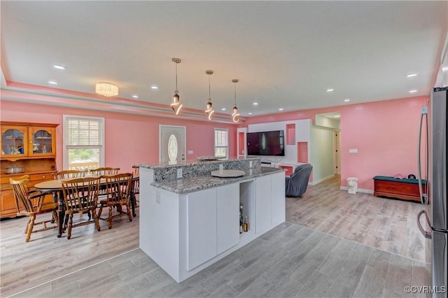 343 Liberty Rd, Buckingham, VA 23123 - kitchen with light wood-style flooring, freestanding refrigerator, light stone counters, hanging light fixtures, and recessed lighting