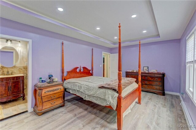 343 Liberty Rd, Buckingham, VA 23123 - bedroom featuring a raised ceiling, light wood-style flooring, recessed lighting, baseboards, and connected bathroom
