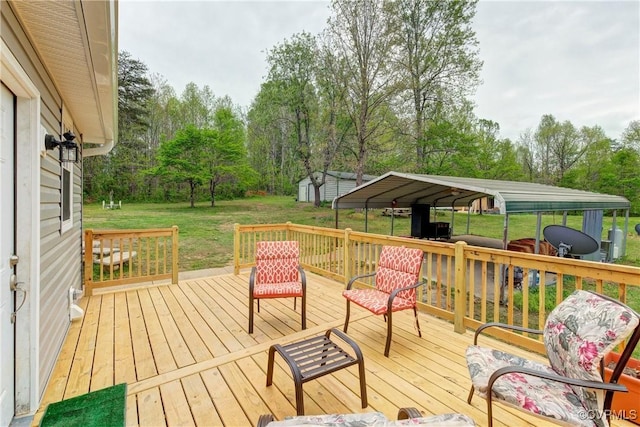 343 Liberty Rd, Buckingham, VA 23123 - wooden terrace with a yard, view of scattered trees, a detached carport, a storage shed, and an outbuilding
