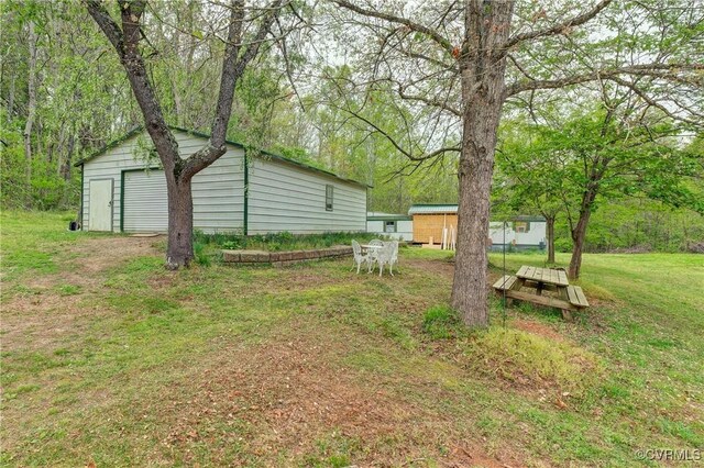 343 Liberty Rd, Buckingham, VA 23123 - view of grassy yard with an outdoor structure and a garage