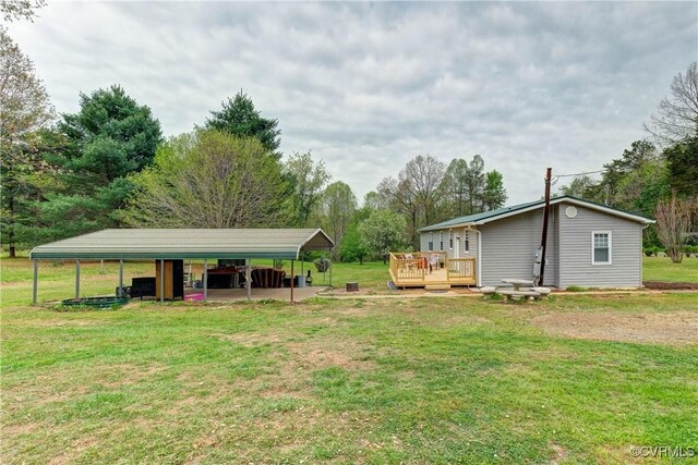 343 Liberty Rd, Buckingham, VA 23123 - view of grassy yard featuring a detached carport and a deck