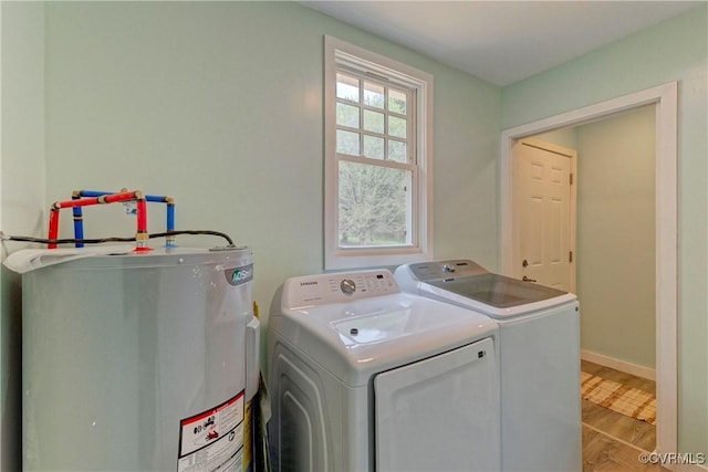 343 Liberty Rd, Buckingham, VA 23123 - laundry area with water heater, washer and clothes dryer, wood finished floors, and baseboards