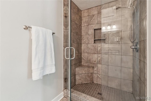 full bath with a stall shower and baseboards