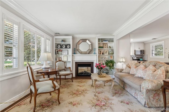 living room with crown molding, a multi sided fireplace, wood finished floors, and built in shelves