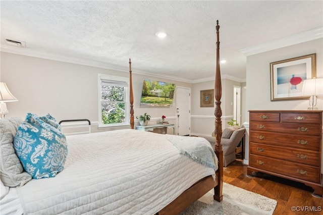 bedroom featuring crown molding, visible vents, a textured ceiling, and wood finished floors