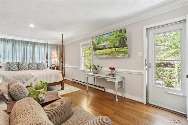 bedroom featuring a baseboard radiator, ornamental molding, baseboards, and wood finished floors