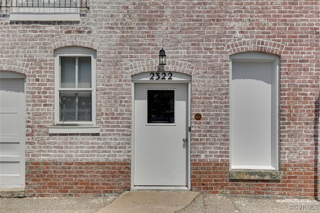 entrance to property with brick siding