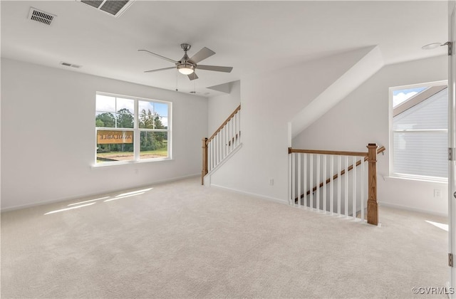 carpeted spare room featuring ceiling fan and visible vents