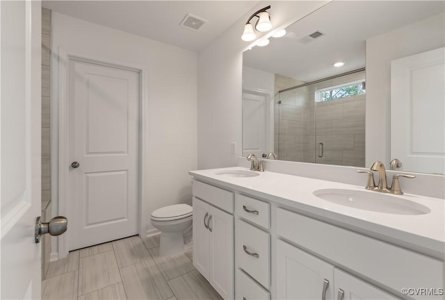 bathroom with visible vents, a sink, and a stall shower