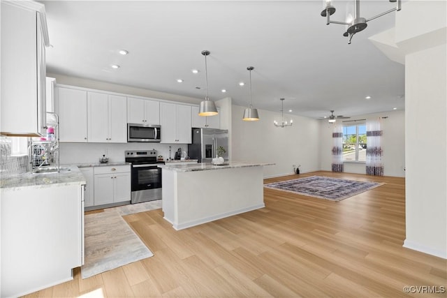 925 Scott Commons Ln, Henrico, VA 23227 - kitchen featuring ceiling fan with notable chandelier, stainless steel appliances, open floor plan, recessed lighting, and a kitchen island