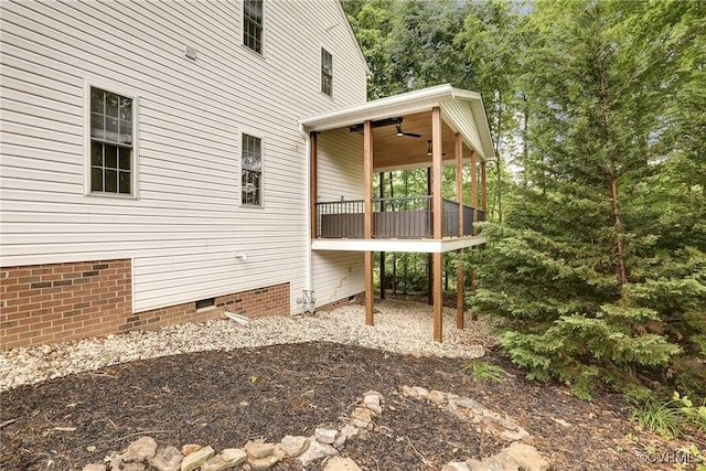 view of side of property with crawl space and a ceiling fan