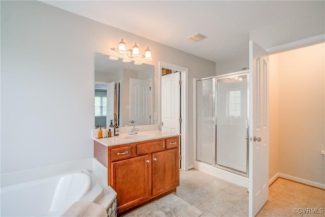 full bathroom featuring tile patterned flooring, a shower stall, vanity, a tub, and baseboards