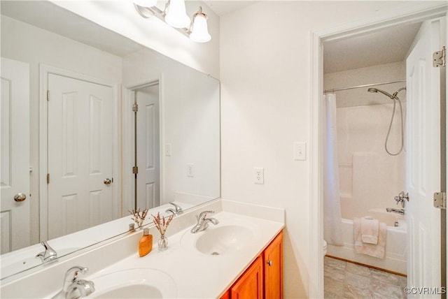 bathroom with double vanity, toilet, and shower / bath combo
