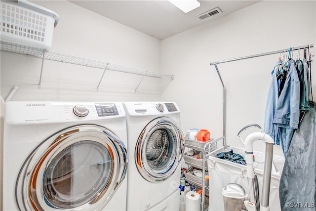 clothes washing area featuring separate washer and dryer