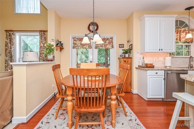 dining room with baseboards and wood finished floors