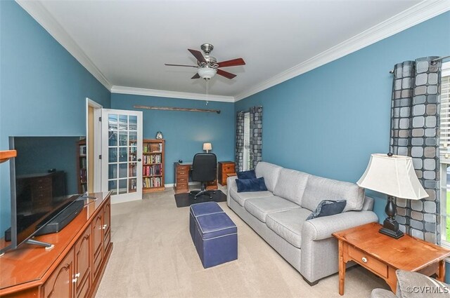 living room featuring crown molding, a ceiling fan, baseboards, and light colored carpet