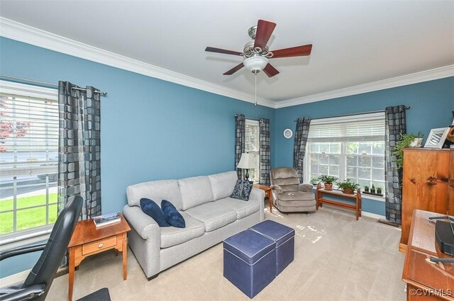living room with baseboards, ornamental molding, a ceiling fan, and carpet flooring