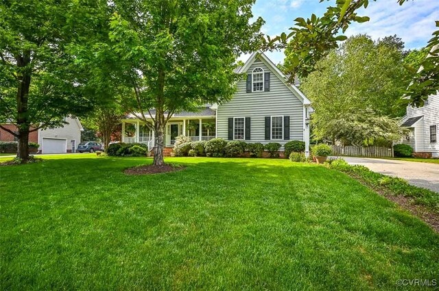 view of property hidden behind natural elements with a front yard