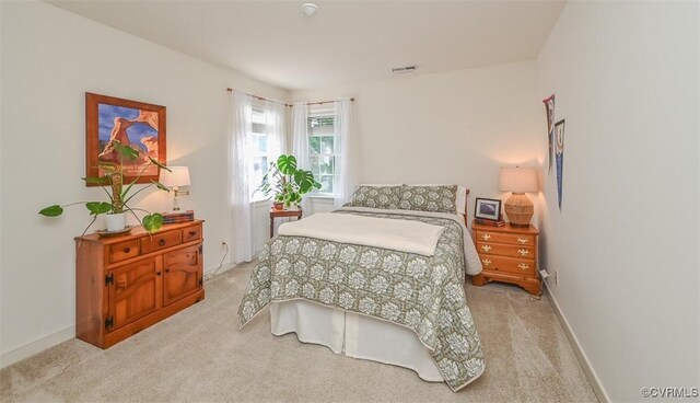 carpeted bedroom with baseboards and visible vents