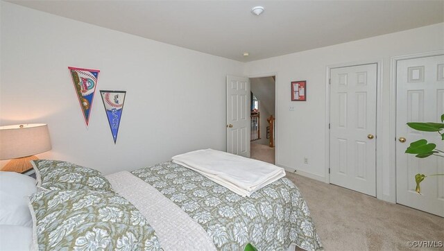 bedroom featuring light colored carpet