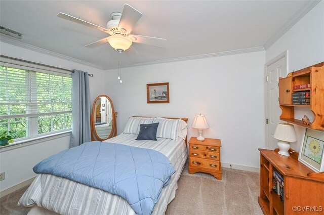 carpeted bedroom with visible vents, ornamental molding, and baseboards