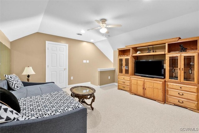 bedroom featuring light colored carpet, vaulted ceiling, and visible vents