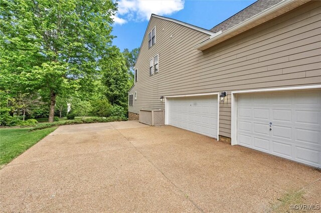 view of home's exterior with driveway and a garage