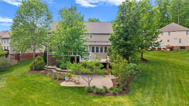 back of house with a lawn