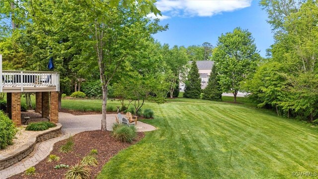 view of yard with a patio and a wooden deck