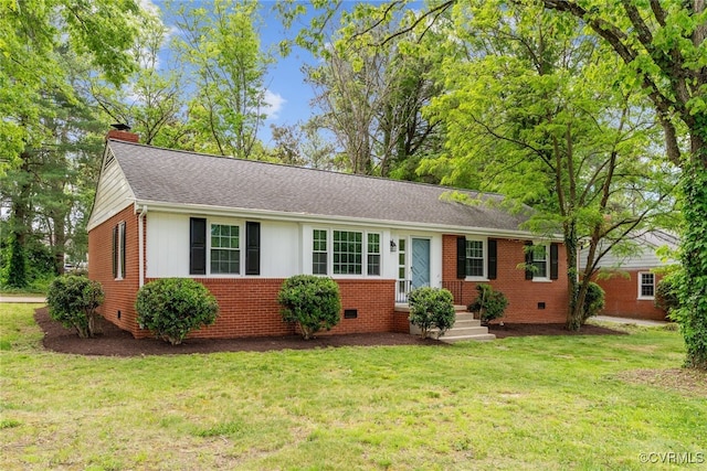 ranch-style house featuring a chimney, brick siding, a front lawn, and roof with shingles