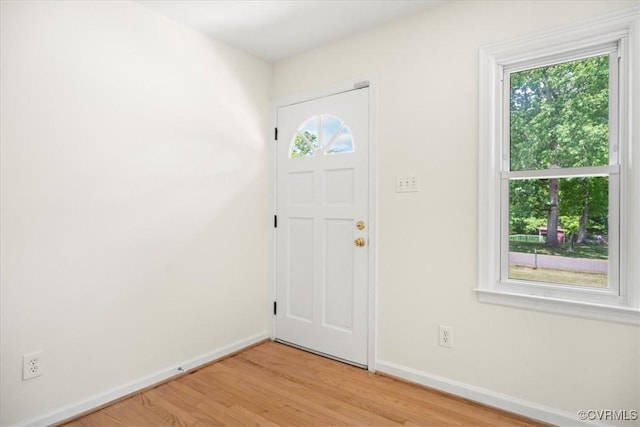 foyer featuring baseboards and light wood-style floors