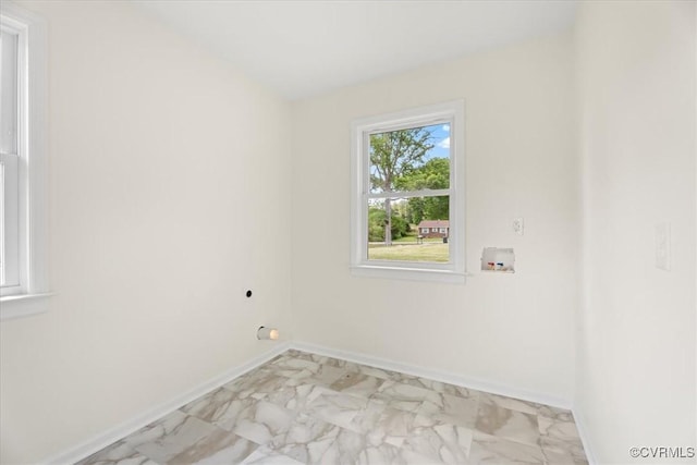 clothes washing area with baseboards, hookup for an electric dryer, laundry area, and washer hookup