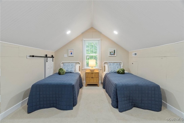 bedroom with a barn door, lofted ceiling, and carpet flooring