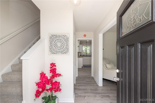 entryway featuring stairs and wood finished floors