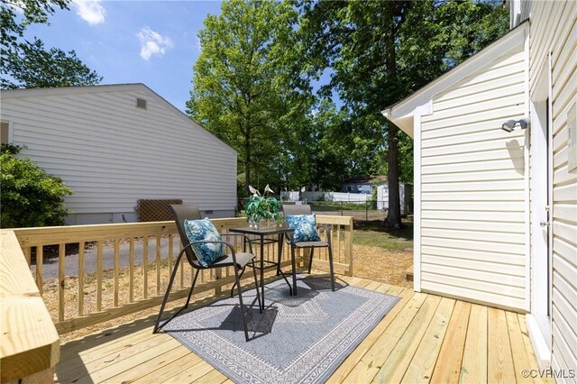 wooden terrace featuring fence