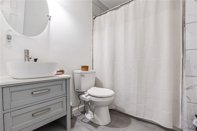 full bathroom with vanity, concrete flooring, and toilet