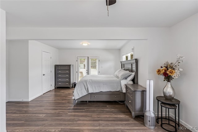 bedroom featuring baseboards and dark wood-type flooring