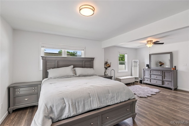 bedroom featuring baseboards, ceiling fan, and dark wood-type flooring