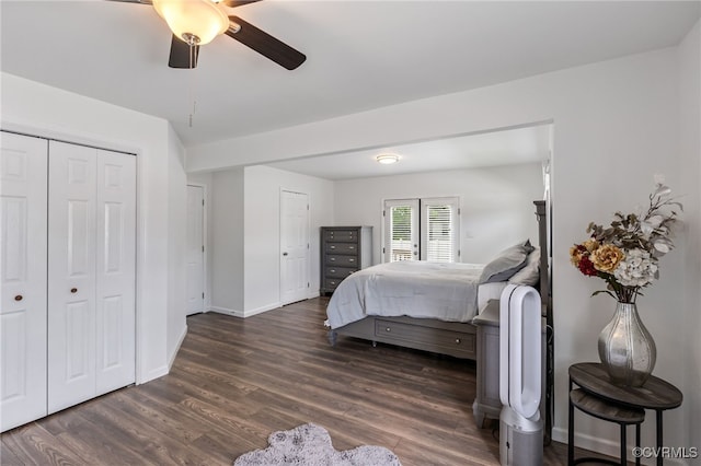 bedroom featuring baseboards, ceiling fan, a closet, and dark wood finished floors
