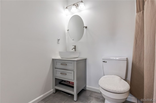 full bath featuring vanity, tile patterned flooring, baseboards, and toilet