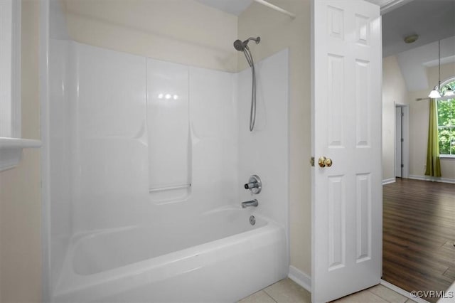 full bath with baseboards, shower / tub combination, and tile patterned flooring