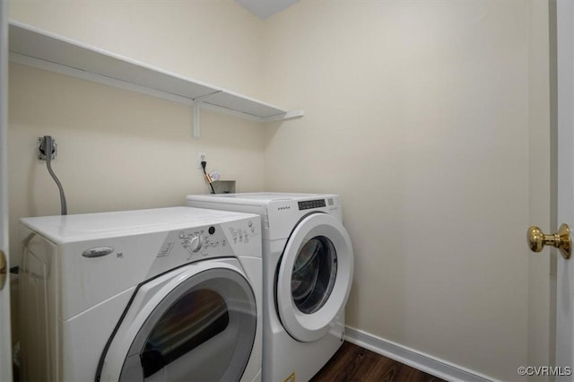 laundry area with laundry area, dark wood-type flooring, baseboards, and independent washer and dryer