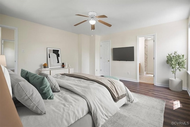 bedroom with baseboards, ceiling fan, ensuite bath, and dark wood-style floors