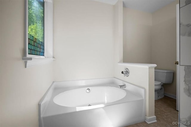 full bathroom with a bath, tile patterned floors, and toilet