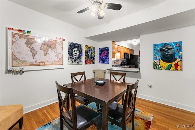 dining area with baseboards, ceiling fan, and wood finished floors