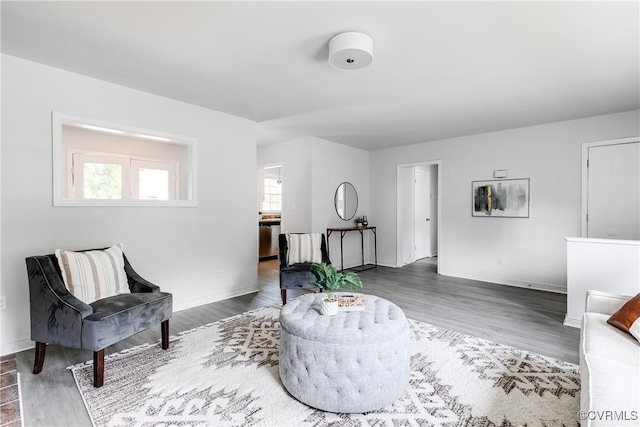 interior space with baseboards and wood finished floors